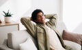 Peaceful black teenager resting on comfy couch at home during covid-19 lockdown, panorama Royalty Free Stock Photo