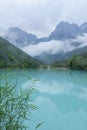 peaceful blue lake with mountain background after rain