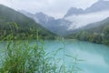 peaceful blue lake with mountain background after rain
