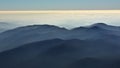 Peaceful blue nature background with foggy Bucegi mountains in Carpathians, Romania