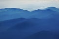 Peaceful blue nature background with foggy Bucegi mountains in Carpathians, Romania