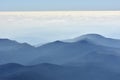 Peaceful blue nature background with foggy Bucegi mountains, Romania