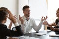 Peaceful businessman meditate ignoring annoying clients talking