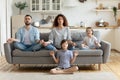 Peaceful calm couple practicing yoga exercises with small children. Royalty Free Stock Photo