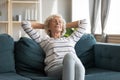 Peaceful calm retired woman relaxing om comfortable sofa. Royalty Free Stock Photo