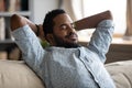 Peaceful carefree biracial guy alone napping on couch indoors. Royalty Free Stock Photo