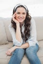 Peaceful casual woman sitting on a cosy couch