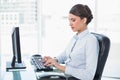 Peaceful classy brown haired businesswoman typing on a computer