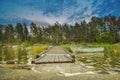 Peaceful cloud landscape on wooden pathway through the lake water and windy water reflection of stadinding cannoe