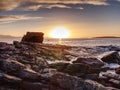 Peaceful dawn at Elgol bay. Low angle overlooking of offshore rocks and smooth sea, mountains Royalty Free Stock Photo