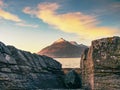 Peaceful dawn at Elgol bay. Low angle overlooking of offshore rocks and smooth sea, mountains Royalty Free Stock Photo