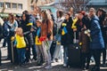 Ukrainians with national flags honor civilians killed in the war in Ukraine.