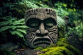 peaceful face of indian god stone tiki mask on ground in forest