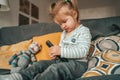 Peaceful female child playing with the TV accessory Royalty Free Stock Photo