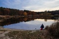 Peaceful fishing on the lake in autumn evening.
