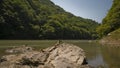 Peaceful flowing Katsura River in Arashikyo Japan surrounded by green trees Royalty Free Stock Photo