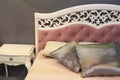 Peaceful fragment of classic luxury bedroom with selective focus at decorative pillows. Royalty Free Stock Photo