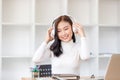 Peaceful girl in modern wireless headphones listening to music, happy calm young woman in earphones rest during study online in Royalty Free Stock Photo