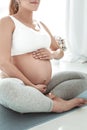 Peaceful good-looking pregnant woman in comfortable clothes