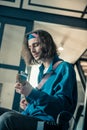 Peaceful handsome young man in bandana focusing on abilities of his instrument