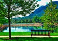 A Peaceful and Idyllic Image at the Broadmoor Hotel at Cheyene Mountain Lake and bench Royalty Free Stock Photo