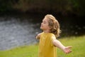 Peaceful kid with raised hands meditating, feeling calm. Kid practice yoga and relaxed on nature. Child faith, praise Royalty Free Stock Photo