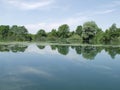 Peaceful lake with clouds reflected in water