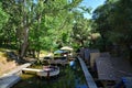 Peaceful lake surrounded by lush forests with several wooden huts perched over the calm water