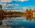 Peaceful lakeside with a scenic nature in fall colors reflecting in the water