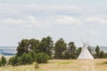 Peaceful Landscape with Trees, Cloudy Sky and Solitary Teepee