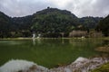 Peaceful landscape with lake surrounded by forest and geothermal activity Royalty Free Stock Photo