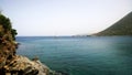 Peaceful landscape - sea, rocks and a yacht in the distance swam into the Bay