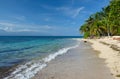 Whit sand beach, palm trees, blue ocean and blue sky. Royalty Free Stock Photo