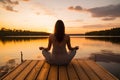 Peaceful lifestyle shot of woman sitting on dock at sunset on Lake