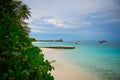 Peaceful luxure view on turquoise ocean and boat berth on tropical island in the evening