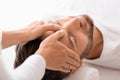 Peaceful man getting healing head massage at spa Royalty Free Stock Photo