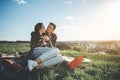 Peaceful man and woman enjoying spending time together on meadow Royalty Free Stock Photo