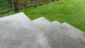 Peaceful meditative scene of rain drops falling on croncrete stairs in summer garden. Rainy day. Freshness of overcast