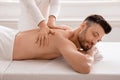 Peaceful middle aged man attending luxury spa salon Royalty Free Stock Photo