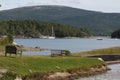 Peaceful mountain scene with lake, boats, bench, grass