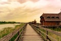 Peaceful nature at the Lake FertÃâ in Hungary with wooden pier bungalows cabins on the lake and straw in the water at