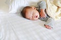 Peaceful newborn Asian baby boy sleeping on bed with the blanket Royalty Free Stock Photo