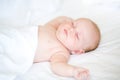 Peaceful newborn baby lying on a bed sleeping Royalty Free Stock Photo