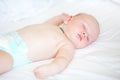 Peaceful newborn baby lying on a bed sleeping Royalty Free Stock Photo