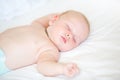 Peaceful newborn baby lying on a bed sleeping Royalty Free Stock Photo