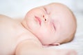 Peaceful newborn baby lying on a bed sleeping Royalty Free Stock Photo