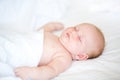 Peaceful newborn baby lying on a bed sleeping Royalty Free Stock Photo
