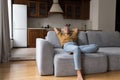 Peaceful older woman leaned on sofa relaxing at home