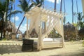 Peaceful place with palm trees and white beach cabanas at a resort over white sand Royalty Free Stock Photo