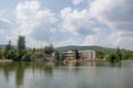 Beautiful peaceful nature, trees and plants on a lake, building amongst the trees, summertime season, reflection in the water